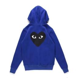 There is a big black heart behind the looped blue cardigan